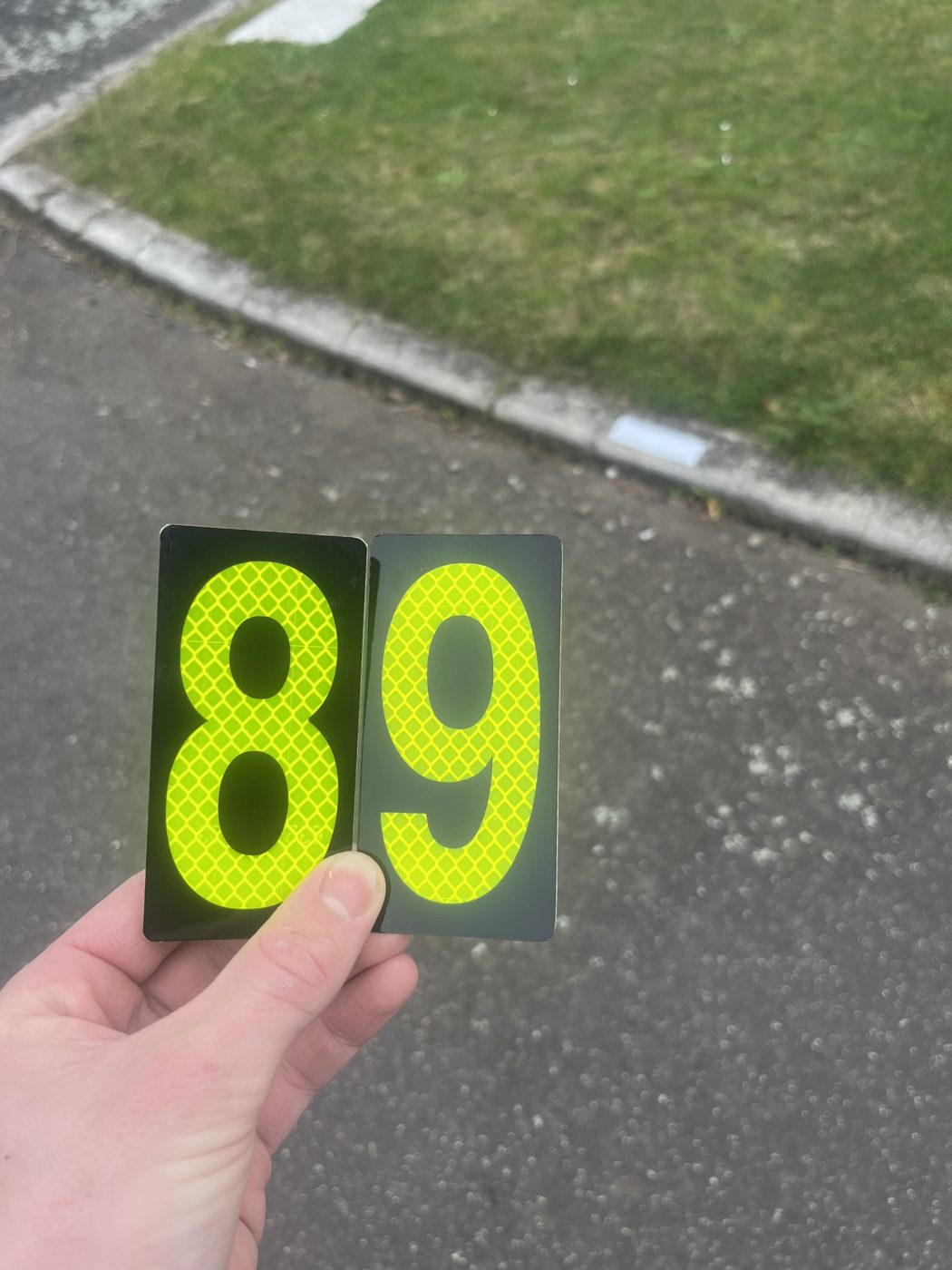 CurbGlow marker held at an angle showing the reflective sheeting pattern